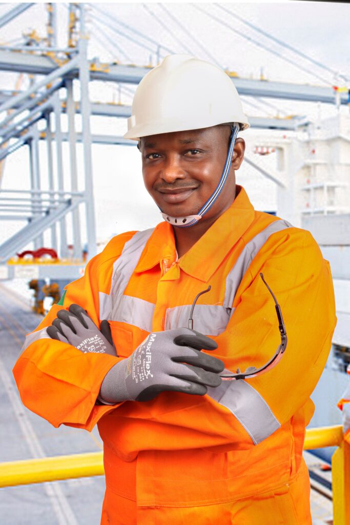 Safety glasses, gloves, coverall and hard hat for offshore oil rig personal protective equipment well worn by offshore worker