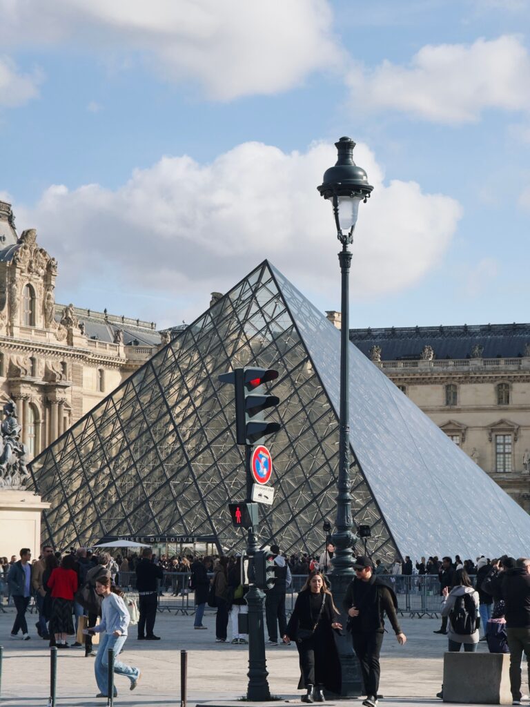 The Louvre Museum's glass pyramid entrance in the early morning