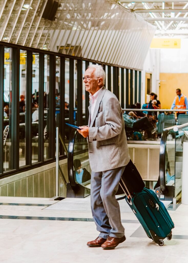 Senior traveler with luggage arriving at a US airport to visit family