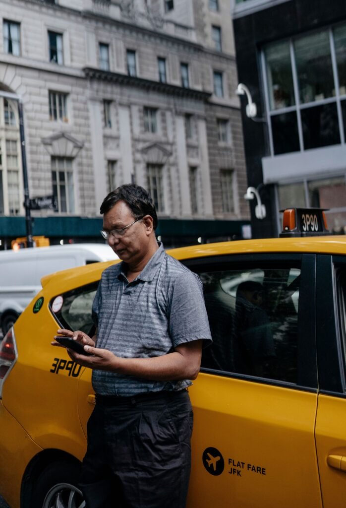 Traveler checking smartphone with eSIM data plan after arriving in New York.